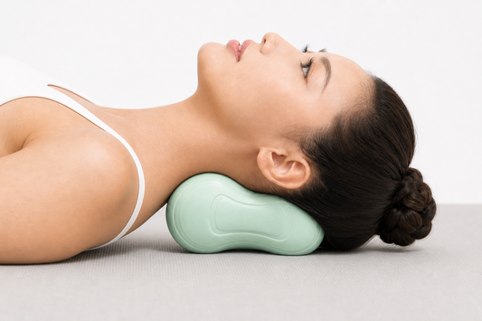 Peanut-shaped neck support ball contoured to fit the neck curve